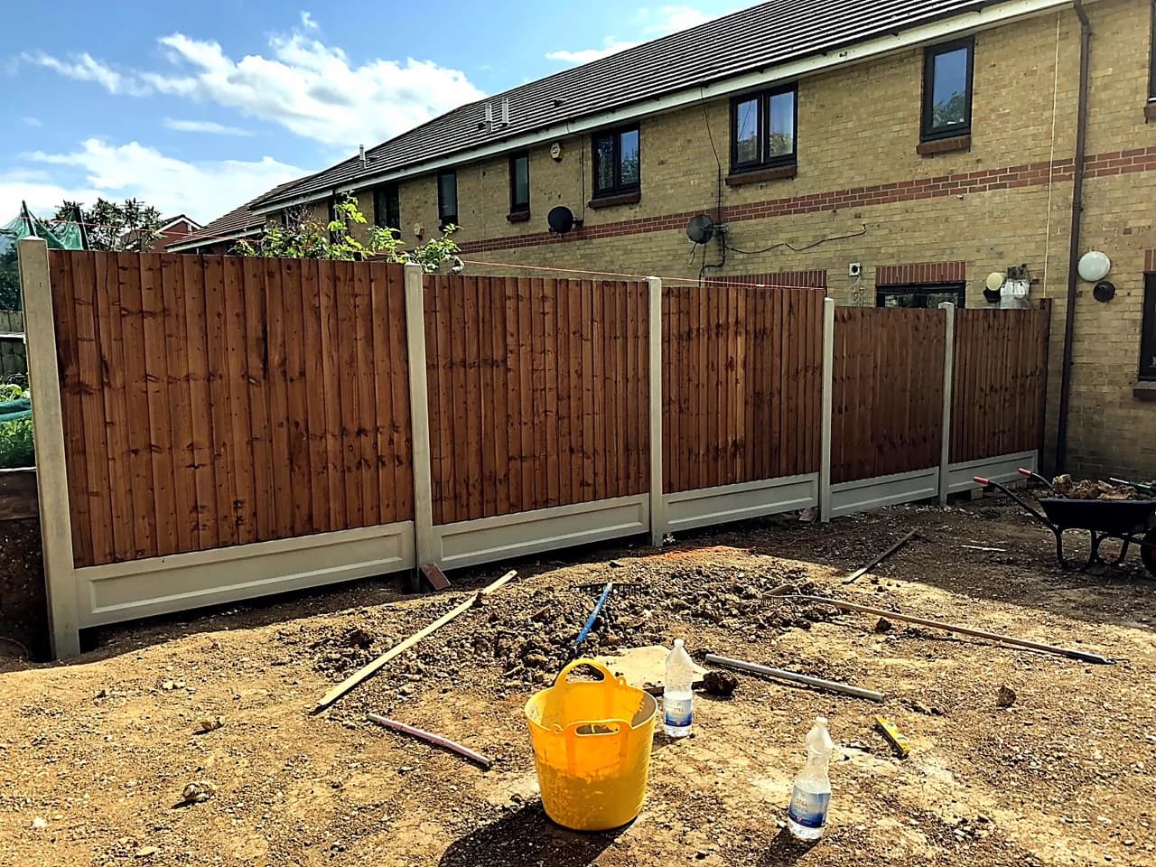 Timber fence panels set between concrete posts around a residential garden.